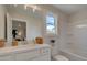 Bright bathroom featuring a tub and shower combination, large mirror, and vanity with storage at 110 Prescott Manor Dr, Canton, GA 30115