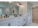 Bathroom featuring double vanity, a large mirror, and walk-in shower with glass surround at 110 Prescott Manor Dr, Canton, GA 30115