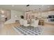 Elegant dining room with a glass table, white chairs, modern lighting, and seamless access to the kitchen at 110 Prescott Manor Dr, Canton, GA 30115