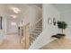 Inviting entryway with a staircase, light hardwood floors, elegant lighting, and decorative accents at 110 Prescott Manor Dr, Canton, GA 30115