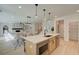 Open concept kitchen with a large island, stainless steel appliances, and seamless flow into the dining and living areas at 110 Prescott Manor Dr, Canton, GA 30115