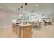 Open floor plan with stainless appliances, an island and view into the living and dining room areas at 110 Prescott Manor Dr, Canton, GA 30115