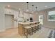 Modern kitchen featuring an island with seating, sleek white cabinetry, and stainless steel appliances at 110 Prescott Manor Dr, Canton, GA 30115