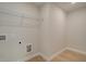 Spacious laundry room with laminate floors, wire shelving and utility connections at 110 Prescott Manor Dr, Canton, GA 30115