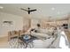 Bright and airy living room with a plush white sofa, stylish rug, and open floor plan leading to the kitchen at 110 Prescott Manor Dr, Canton, GA 30115
