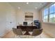 Well-lit home office featuring a large window, modern desk, comfortable seating, and contemporary artwork at 110 Prescott Manor Dr, Canton, GA 30115