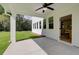 Covered patio with ceiling fan overlooking a lush green backyard and trees at 110 Prescott Manor Dr, Canton, GA 30115