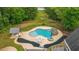 Aerial view of the pool with a slide, outdoor kitchen, jacuzzi and lush green surrounding at 1212 Lee Whatley Dr, Lithonia, GA 30058