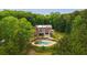 Expansive aerial view showcasing a brick home with an inviting pool area and surrounded by lush greenery at 1212 Lee Whatley Dr, Lithonia, GA 30058