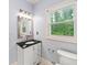 Bathroom featuring a vanity with black countertop, silver hardware and a modern mirror at 1212 Lee Whatley Dr, Lithonia, GA 30058