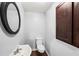 A clean half-bathroom showcasing a pedestal sink and matching dark-wood cabinet at 1212 Lee Whatley Dr, Lithonia, GA 30058