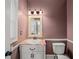 Cozy powder room featuring a vanity with a marble countertop and decorative mirror at 1212 Lee Whatley Dr, Lithonia, GA 30058