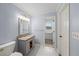 Bathroom with a granite vanity, commode and entrance to the walk-in closet at 1212 Lee Whatley Dr, Lithonia, GA 30058