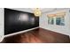 Bedroom with a modern black accent wall and beautiful dark hardwood flooring at 1212 Lee Whatley Dr, Lithonia, GA 30058