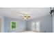 Light blue bedroom with a ceiling fan, plush carpet, a window and a frosted glass door at 1212 Lee Whatley Dr, Lithonia, GA 30058