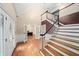 Inviting foyer with hardwood floors, staircase, and office with french doors at 1212 Lee Whatley Dr, Lithonia, GA 30058