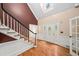 Charming foyer featuring hardwood floors, a staircase, and a sunlit entrance at 1212 Lee Whatley Dr, Lithonia, GA 30058