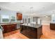 Open-concept kitchen featuring granite countertops, stainless appliances and a large island for gathering at 1212 Lee Whatley Dr, Lithonia, GA 30058