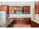 Gourmet kitchen features granite countertops, stainless steel appliances, and cherry wood cabinetry at 1212 Lee Whatley Dr, Lithonia, GA 30058