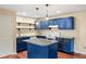 Open kitchen with bright blue cabinetry, granite countertops, and a functional center island at 1212 Lee Whatley Dr, Lithonia, GA 30058
