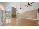 Bright living room with a cathedral ceiling, stone fireplace and large windows at 1212 Lee Whatley Dr, Lithonia, GA 30058