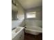 View of a bathroom with a claw foot tub, single sink vanity, wood floors, and a window providing natural light at 2069 Bixler Circle, Decatur, GA 30032