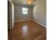 Bright bedroom featuring a ceiling fan, window, hardwood floors, and neutral wall color at 2069 Bixler Circle, Decatur, GA 30032