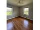 Bedroom featuring two windows, hardwood floors, a ceiling fan, and neutral walls at 2069 Bixler Circle, Decatur, GA 30032