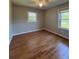 Bedroom showcasing hardwood floors, natural light from two windows, and a ceiling fan at 2069 Bixler Circle, Decatur, GA 30032
