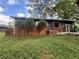 Cozy one-story brick home featuring a screened-in porch, mature trees, and a well-maintained lawn at 2069 Bixler Circle, Decatur, GA 30032