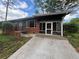 Quaint brick home featuring a screened-in porch and a long concrete driveway at 2069 Bixler Circle, Decatur, GA 30032