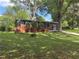 Charming one-story brick home featuring a screened-in porch, mature trees, and a well-maintained lawn at 2069 Bixler Circle, Decatur, GA 30032