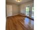 Bright room featuring hardwood floors, a door to the backyard, and fresh paint at 2069 Bixler Circle, Decatur, GA 30032