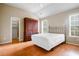 Bright bedroom featuring a bed, closet, and two windows for natural light at 2108 Waters Edge Trl, Roswell, GA 30075