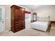 Bedroom with large wardrobe, full-sized bed, and private door to the backyard at 2108 Waters Edge Trl, Roswell, GA 30075