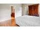 Bedroom with closet, bathroom access, wood floors, and neutral walls at 2108 Waters Edge Trl, Roswell, GA 30075