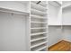 This walk-in closet provides ample storage with multiple shelves and hanging rods at 2108 Waters Edge Trl, Roswell, GA 30075