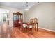 Dining room features wooden table set, hardwood flooring, and an elegant light fixture at 2108 Waters Edge Trl, Roswell, GA 30075