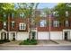 Charming brick townhomes with individual garages and well-maintained landscaping at 2108 Waters Edge Trl, Roswell, GA 30075