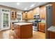 Well-lit kitchen features an island, stainless steel appliances, and lots of cabinet space at 2108 Waters Edge Trl, Roswell, GA 30075