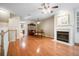 Open living room featuring gleaming hardwood floors, fireplace, and elegant furnishings at 2108 Waters Edge Trl, Roswell, GA 30075