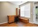 Home office features a built-in desk, shelving, and a window for natural light at 2108 Waters Edge Trl, Roswell, GA 30075
