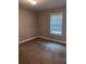 Neutral bedroom features a window for natural light and neutral carpet flooring at 31 Villa Se Ct, Smyrna, GA 30080