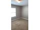 Bright bedroom featuring plush carpeting and natural light from a window with blinds at 31 Villa Se Ct, Smyrna, GA 30080