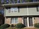 Townhouse exterior featuring a brick facade and shake siding under the windows at 31 Villa Se Ct, Smyrna, GA 30080