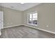 Cozy bedroom with laminate floors, neutral walls, and white blinds on the window at 3302 Dogwood Dr # 123, Atlanta, GA 30354