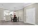 Well-lit dining area featuring modern chandelier and view into the kitchen and entrance at 3302 Dogwood Dr # 123, Atlanta, GA 30354