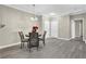 Dining area with modern light fixture, dining table with 4 chairs, and gray flooring at 3302 Dogwood Dr # 123, Atlanta, GA 30354