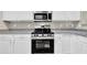 Modern kitchen featuring granite countertops, stainless steel appliances, and white cabinets at 3302 Dogwood Dr # 123, Atlanta, GA 30354
