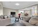Open-concept living space with hardwood floors, a modern TV, and a view into the dining room at 3302 Dogwood Dr # 123, Atlanta, GA 30354